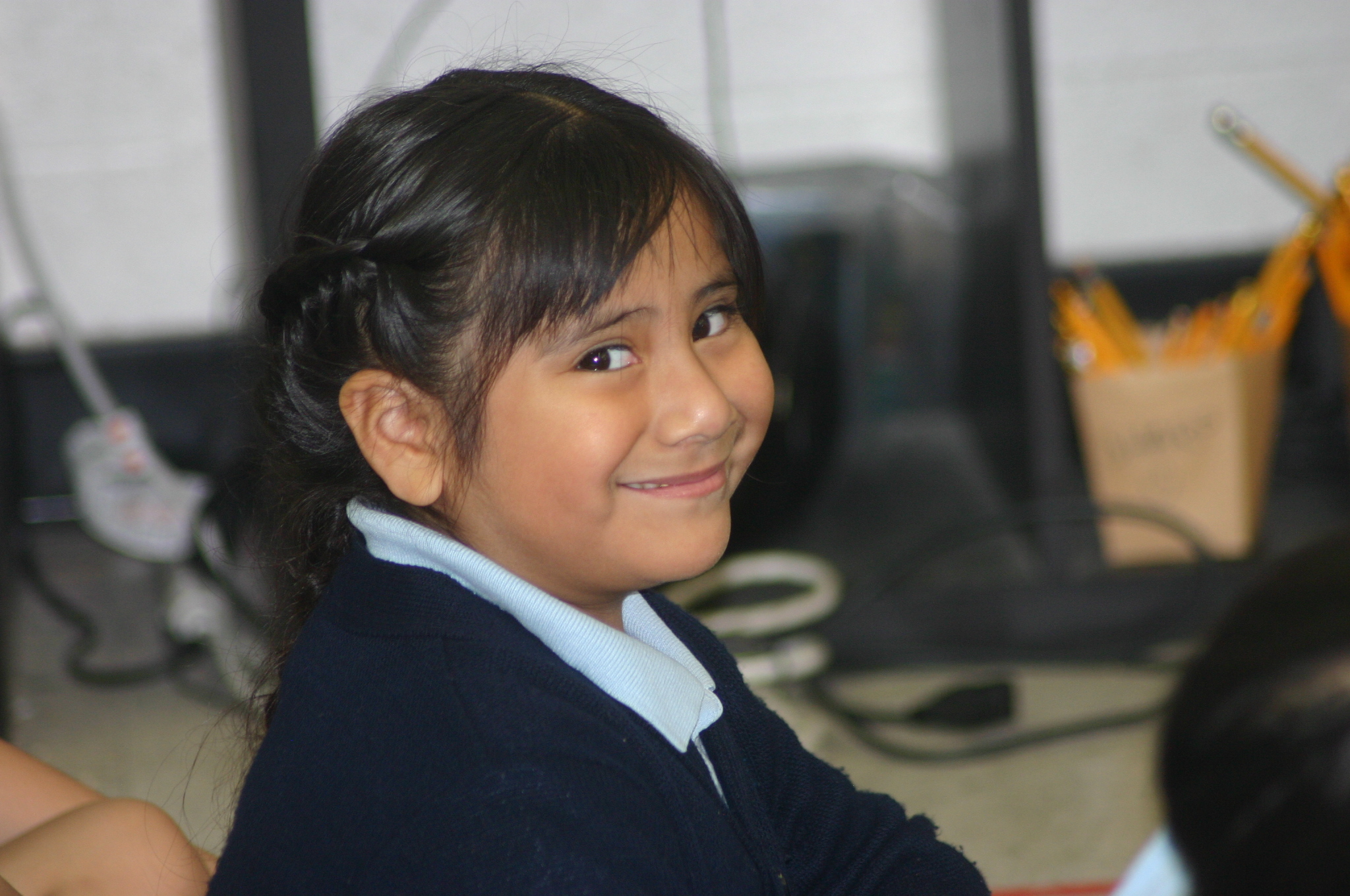 A CASA Academy scholar smiles in the classroom