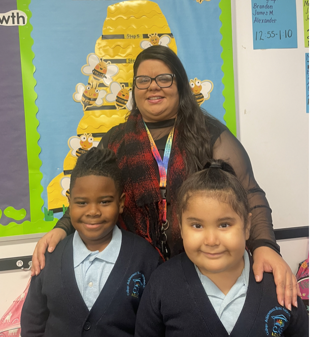 CASA Academy teacher, Alisha Rivera, smiles with 2 students