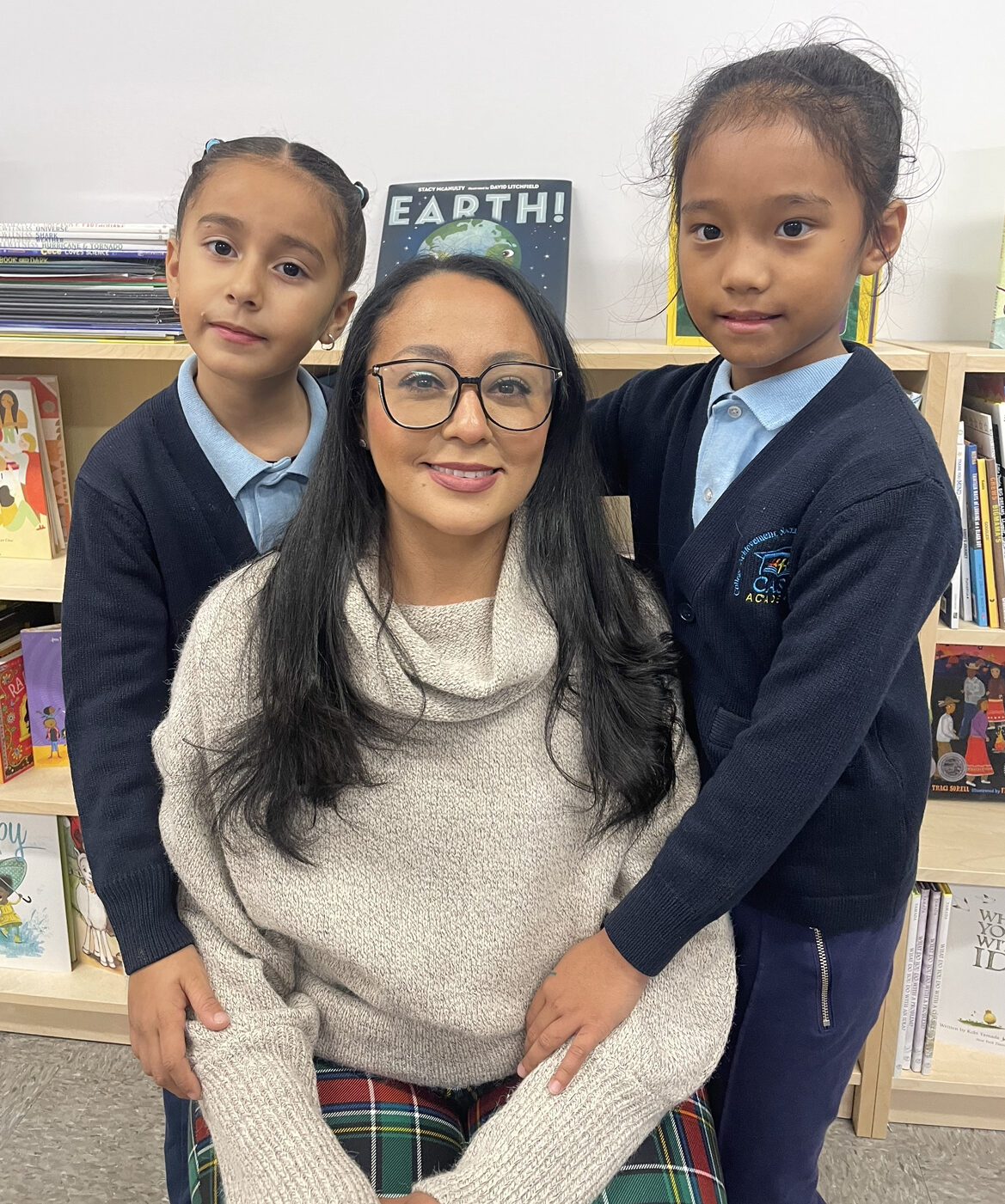 Regina Villalobos smiles with 2 CASA Academy scholars