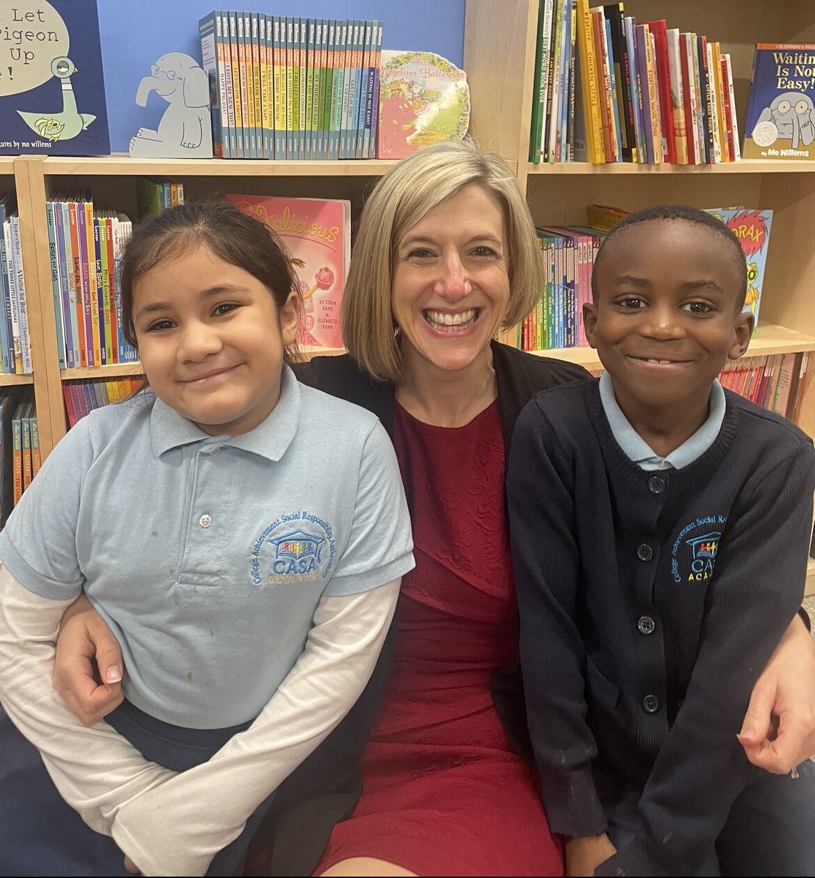 Tacey Clayton Cundy, Founder and CEO of CASA Academy, smiles with 2 scholars